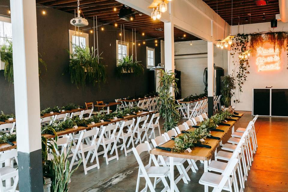 Private event space with long tables and greenery at FruitCraft Fermentery & Distillery.