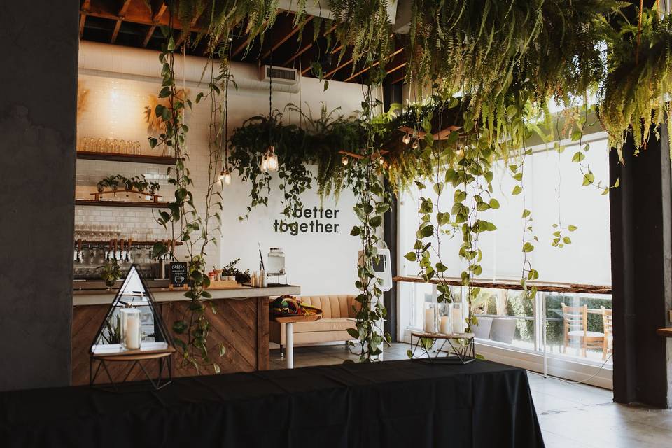 Kombuchery event space with lush greenery, ideal for networking and gatherings.