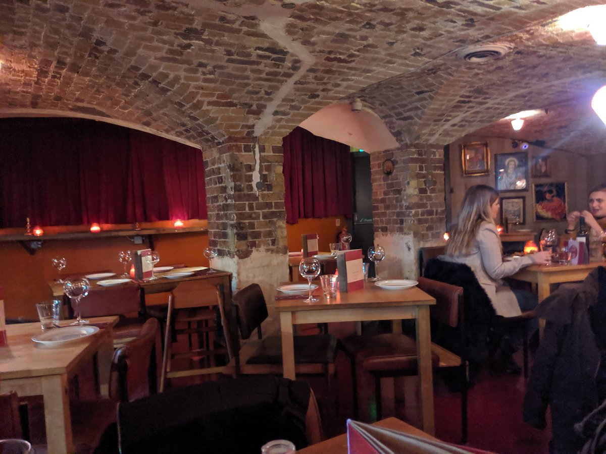 Cozy dining space with exposed brick arches, perfect for private events and gatherings.