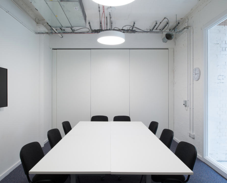 Modern conference room with large table, ideal for meetings and brainstorming sessions.