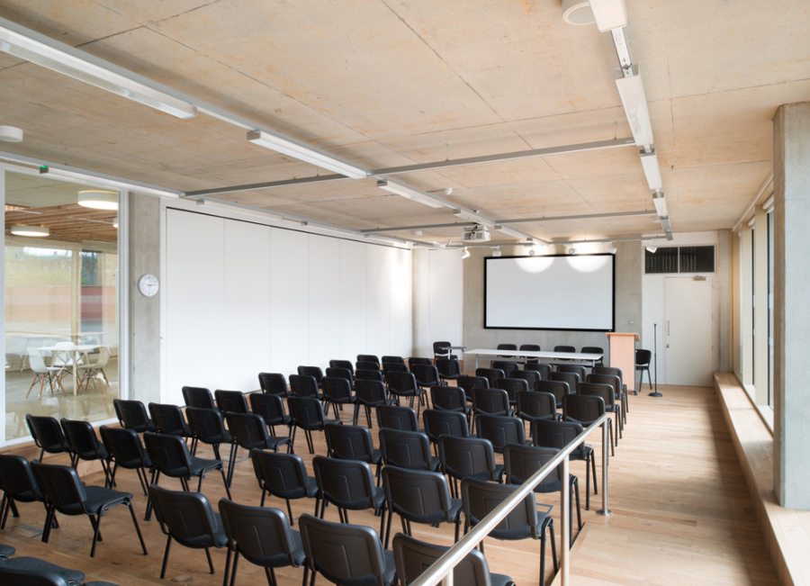 Modern conference room with ample seating for presentations and workshops.