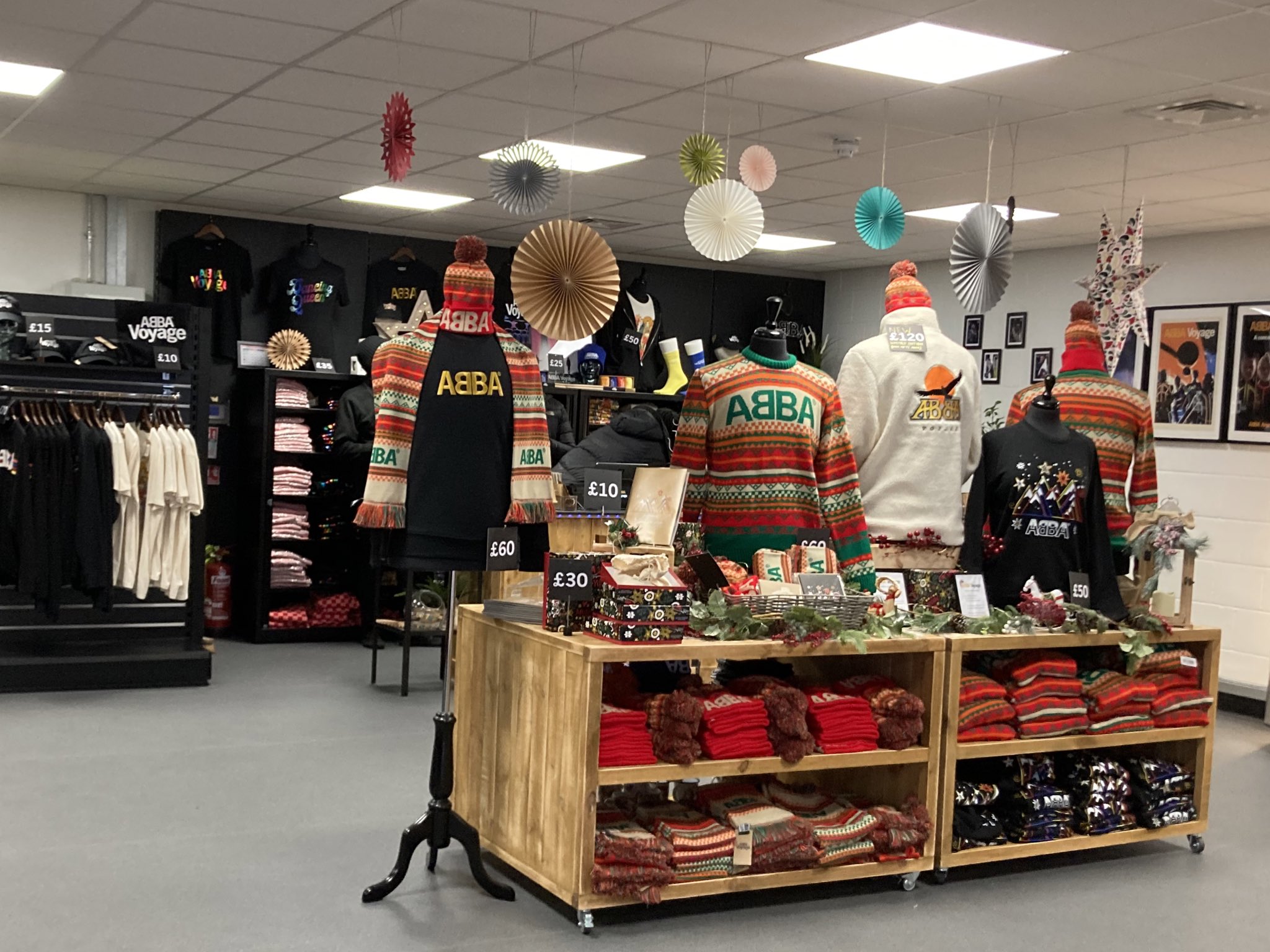 Vibrant ABBA Voyage pop-up shop with colorful merchandise and festive decor.
