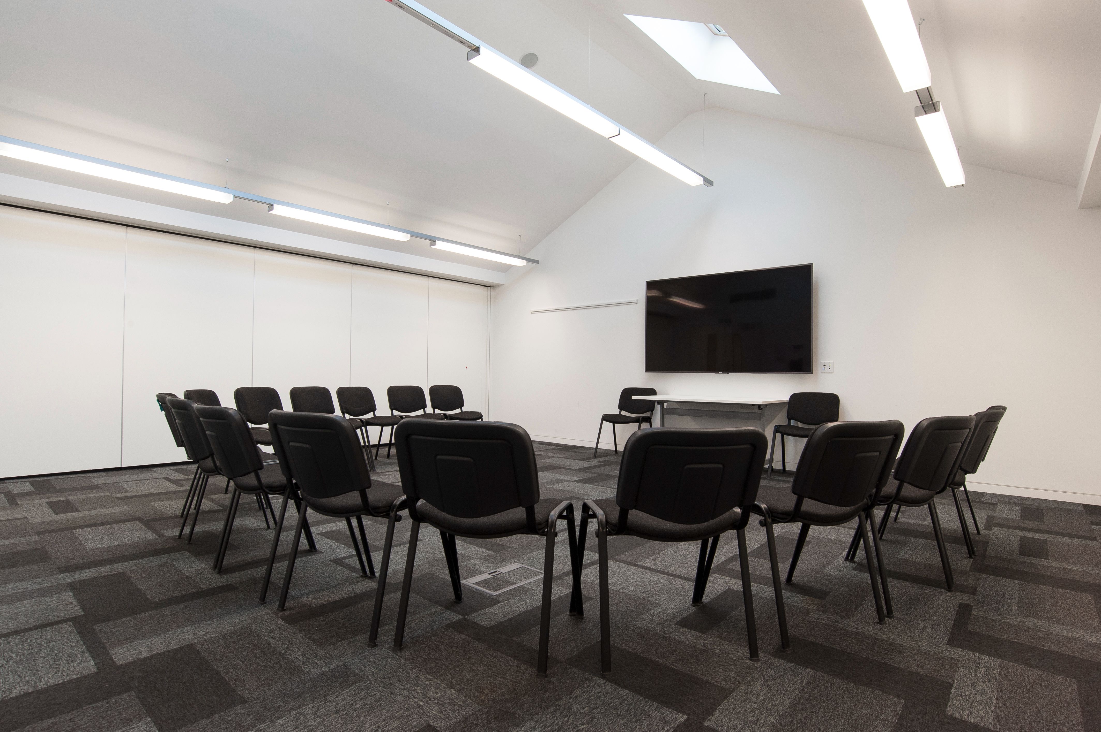 Versatile meeting room with circular seating for workshops and team-building at The Foundry.