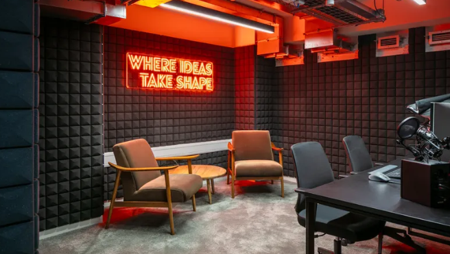 Modern meeting space with neon sign for creative brainstorming sessions.