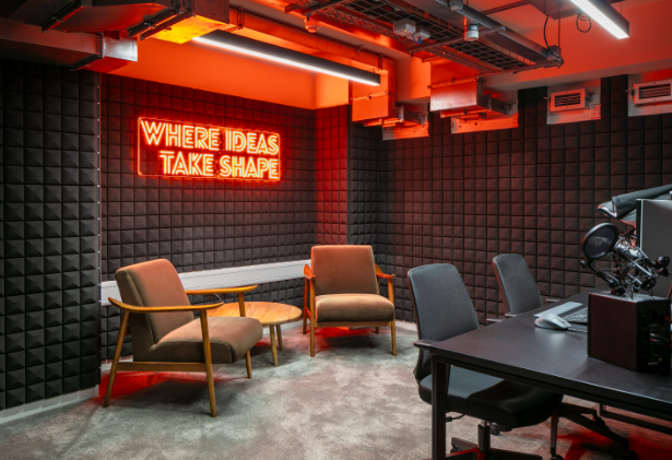 Modern meeting space with neon sign for creative workshops and team collaboration.