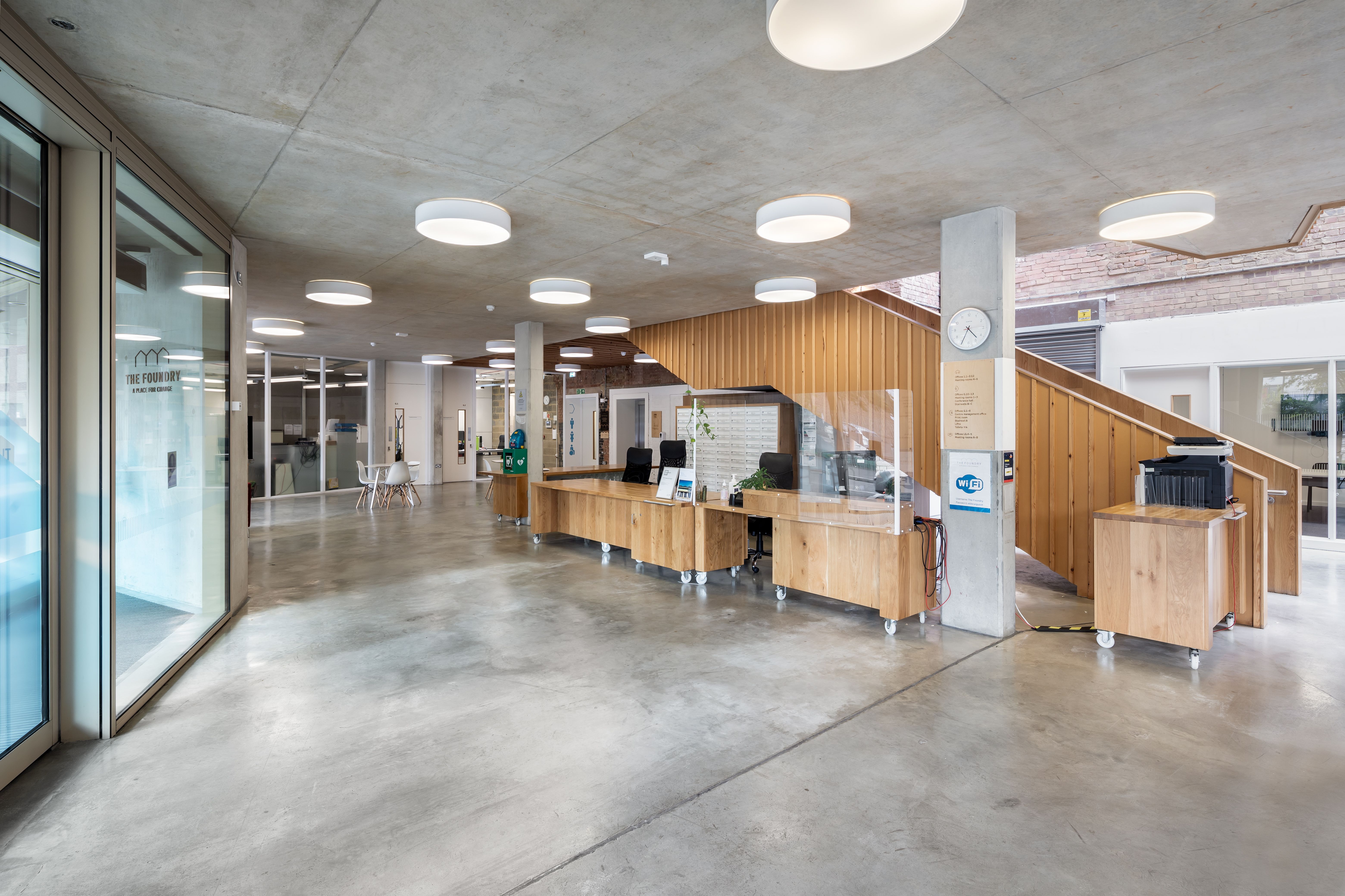 Modern meeting room lobby with natural light, ideal for events and gatherings.