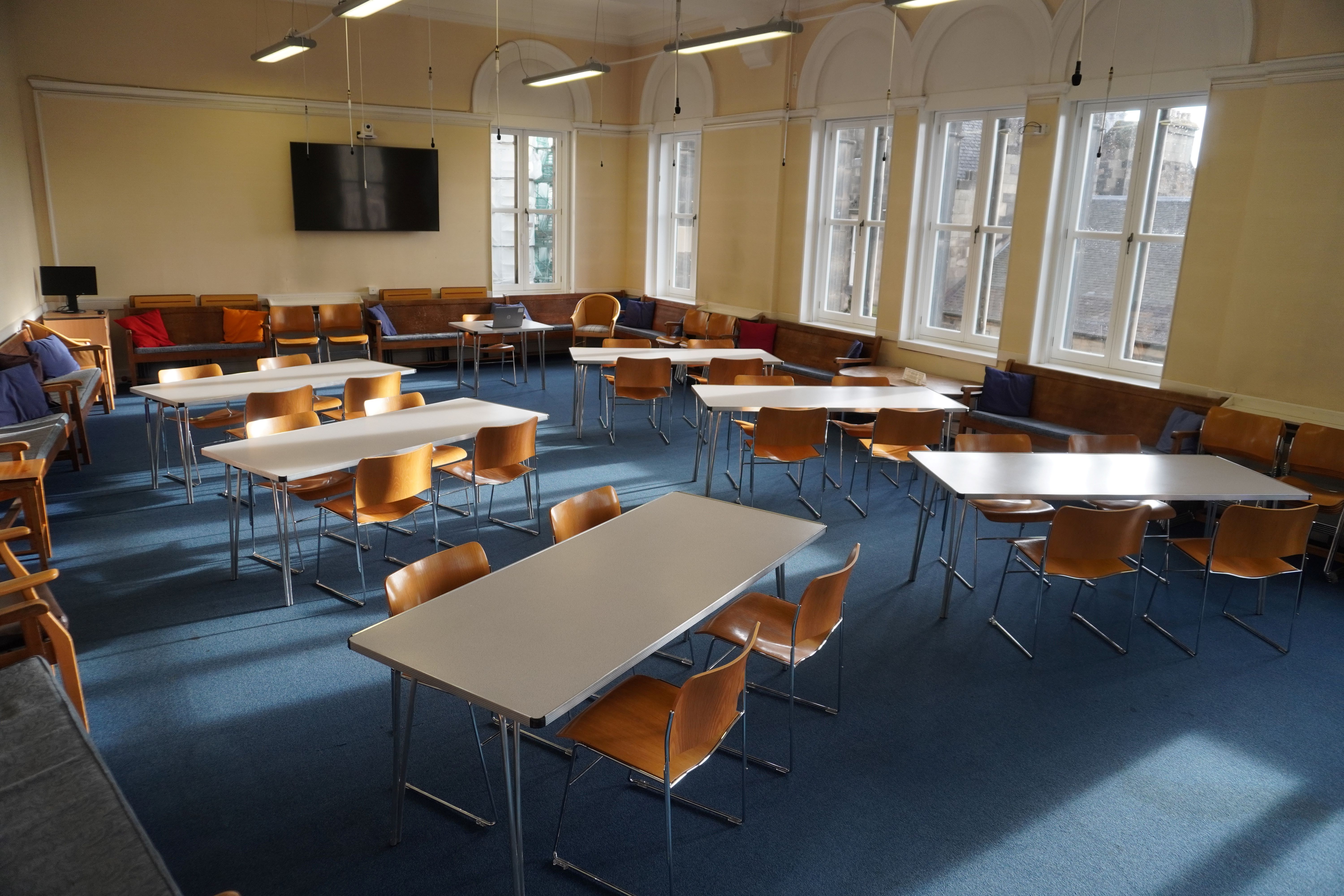 Versatile meeting room with natural light at Edinburgh Quaker Meeting House, ideal for workshops.