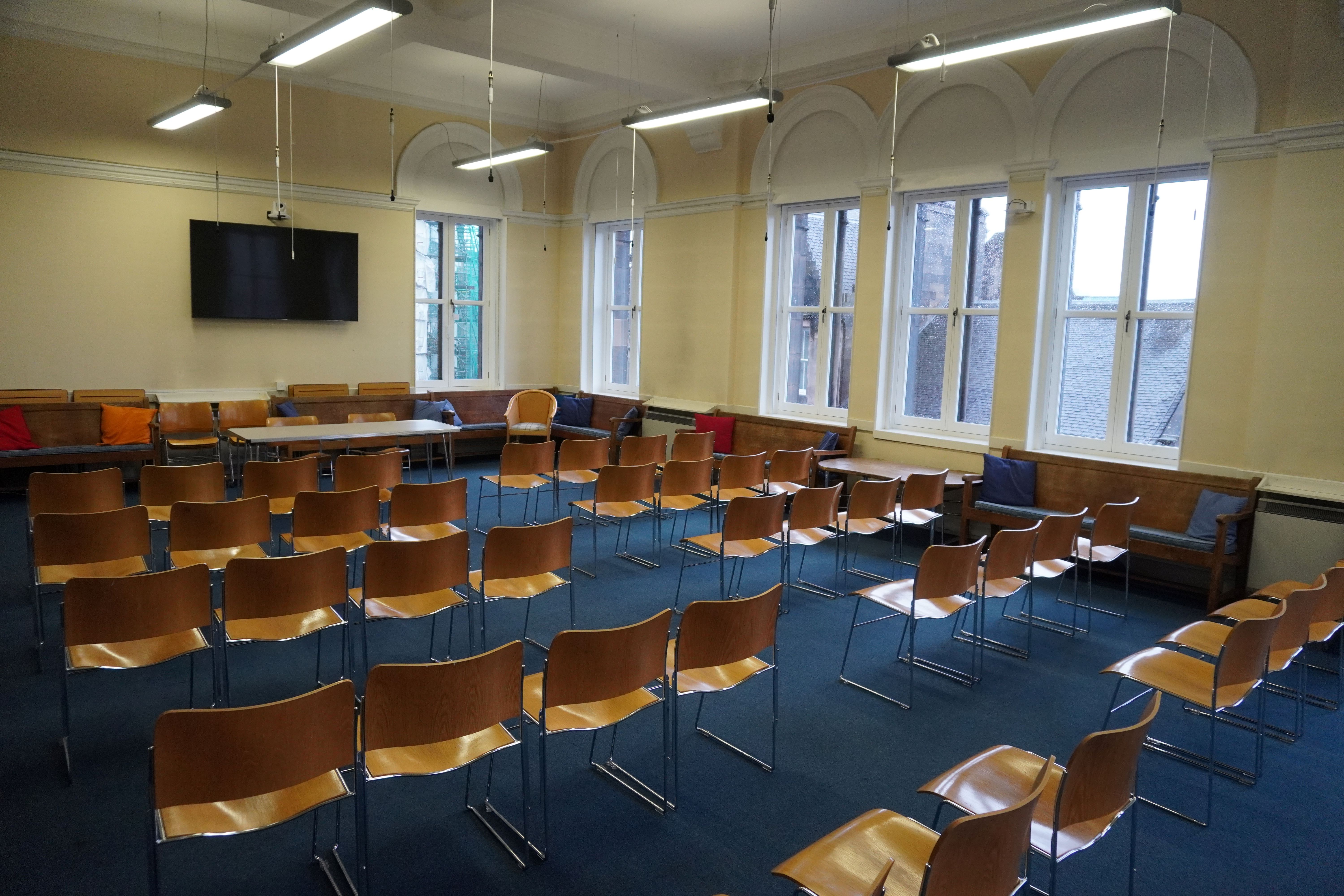 Bright meeting room with chairs for workshops at Edinburgh Quaker Meeting House.