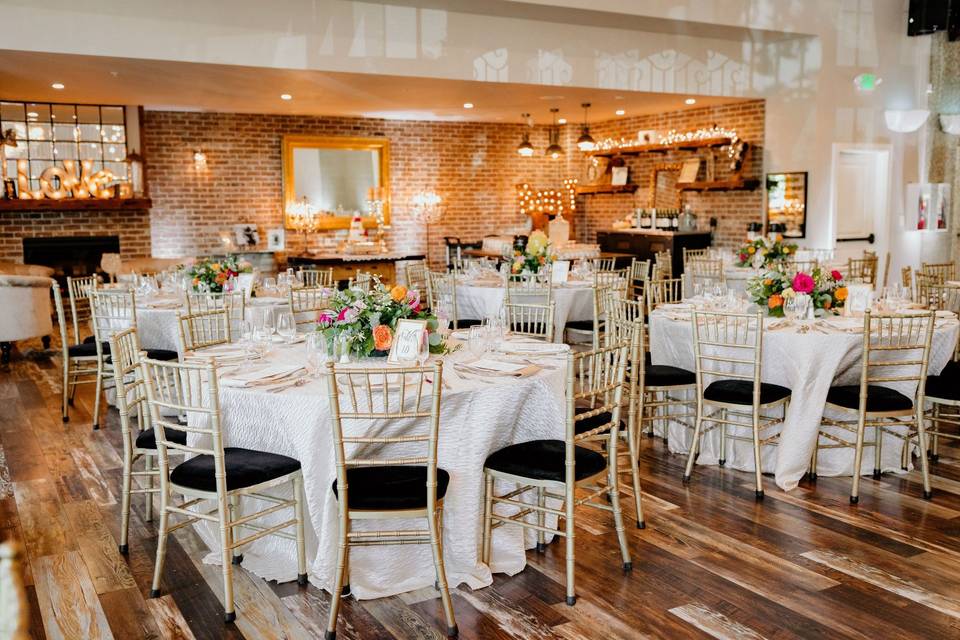 Elegant indoor event space with floral centerpieces, ideal for weddings and gatherings.