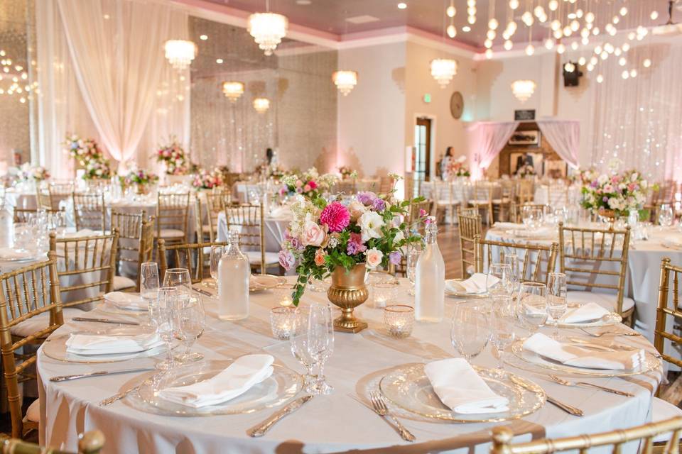 Elegant banquet hall with floral centerpieces, ideal for weddings and upscale events.