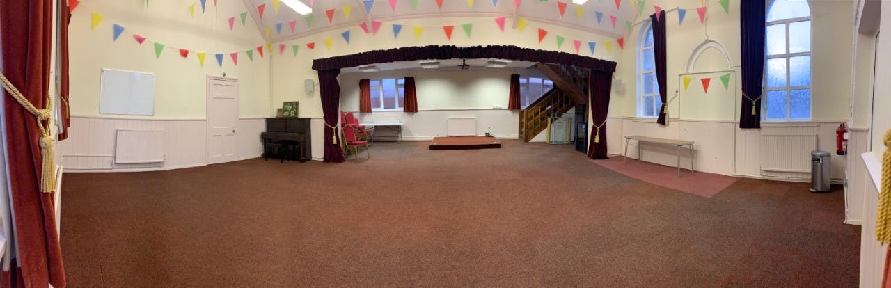 Banquet hall in Foulsham Hall with colorful bunting for events and gatherings.