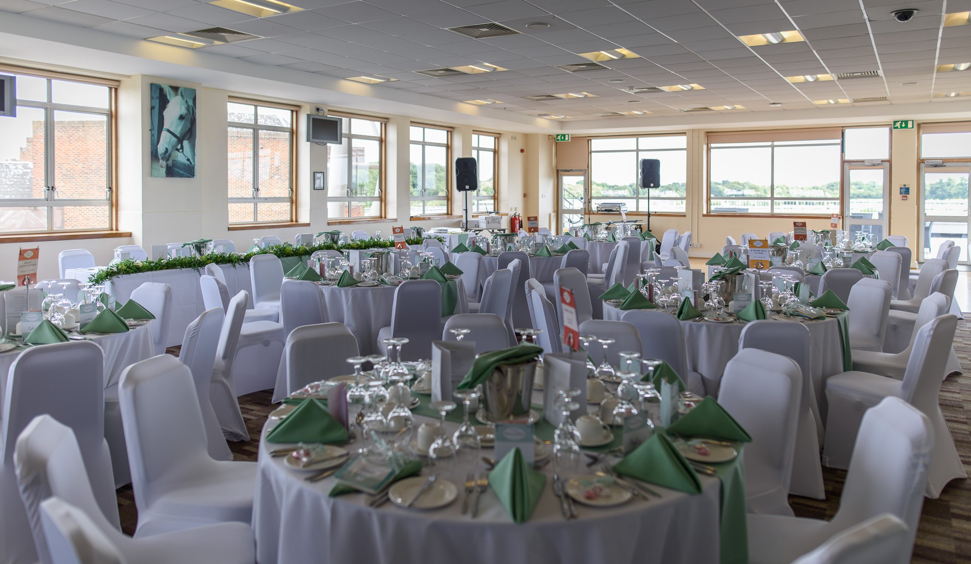 Desert Orchid Suite at Kempton Park, elegant banquet setup with natural light.