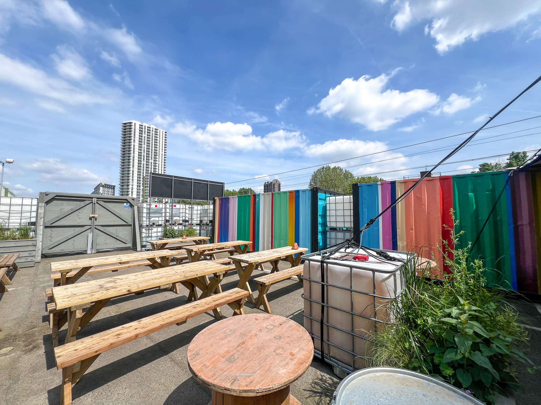 Vibrant outdoor event space with colorful shipping containers for creative gatherings.
