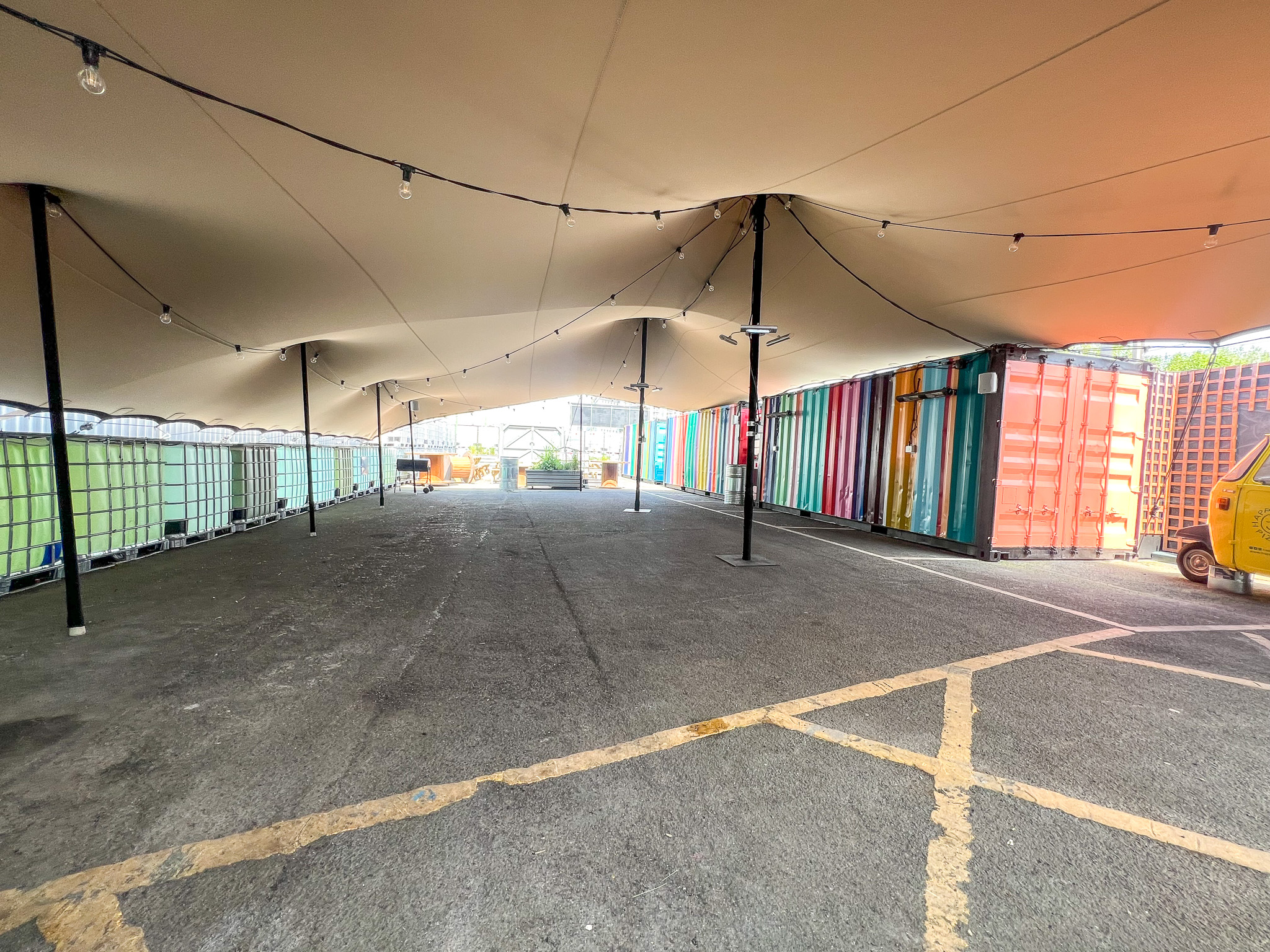 Outdoor event space with tent canopy, ideal for markets and festivals.