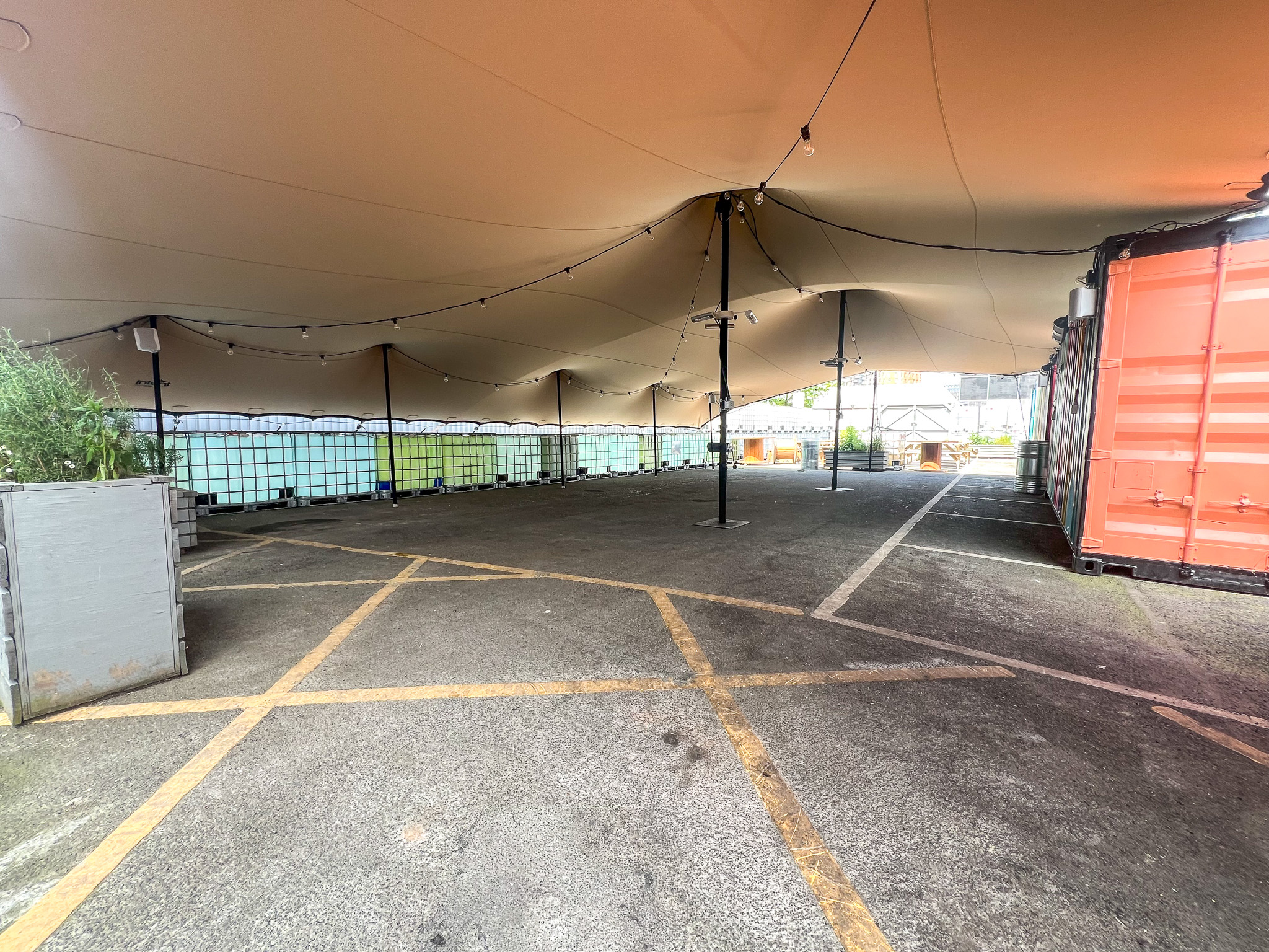 Outdoor event space with canopy, ideal for markets and gatherings.