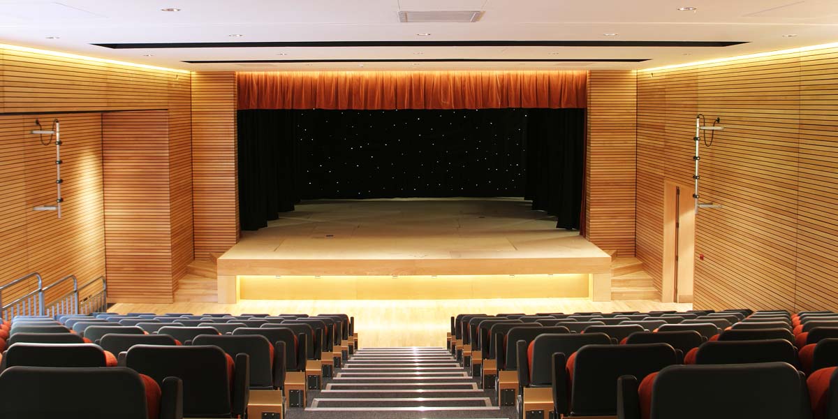 Private event at Hurlingham Yacht Club with tiered seating and elegant stage backdrop.