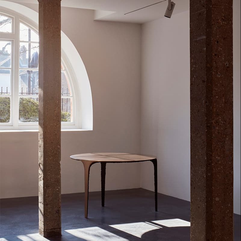 Minimalist meeting space in Ladbroke Hall with modern table and natural light for creative events.