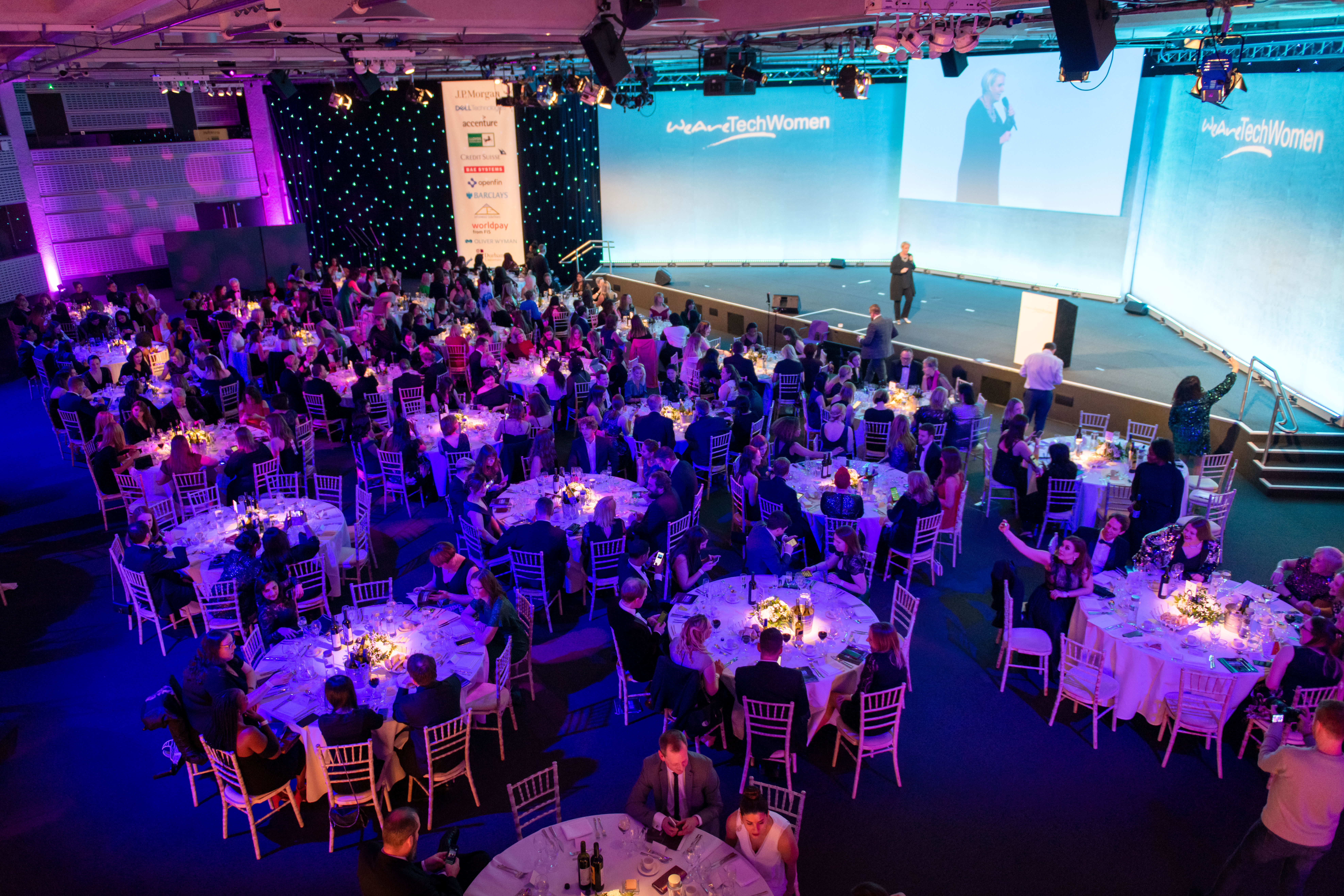 Churchill & Pickwick gala event at QEII Centre with elegantly set tables and vibrant lighting.