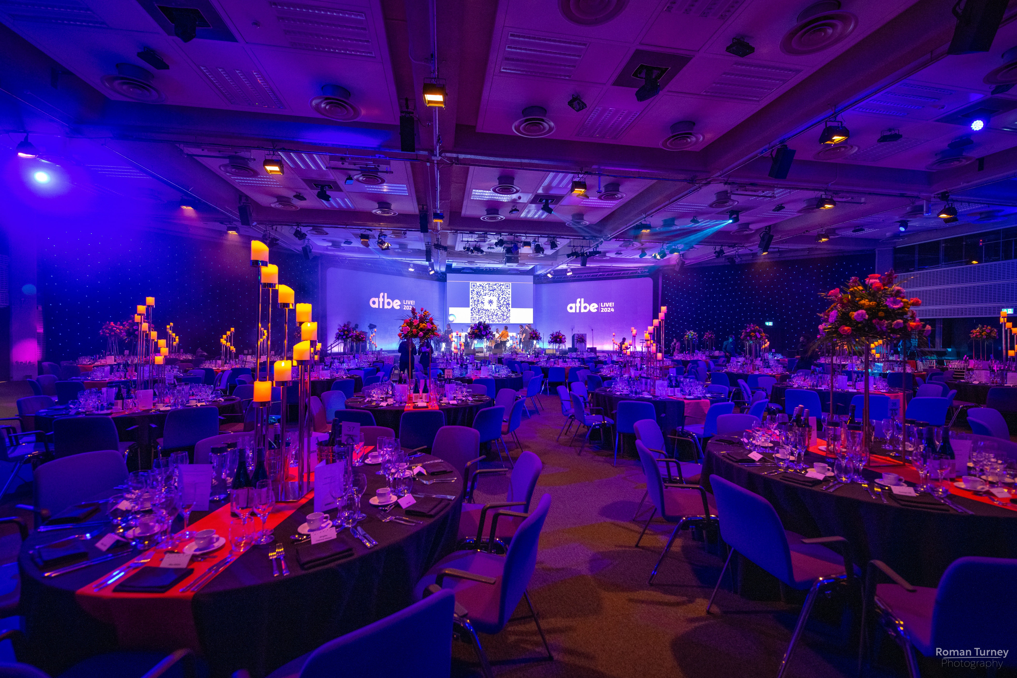 Elegant gala setup at Churchill & Pickwick, featuring floral centerpieces and ambient lighting.