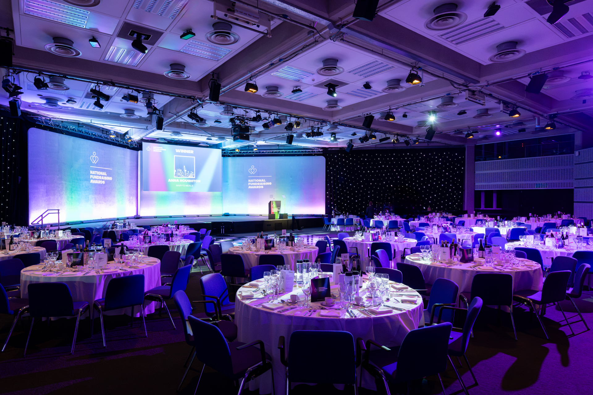 Formal event space at QEII Centre with round tables and professional ambiance.