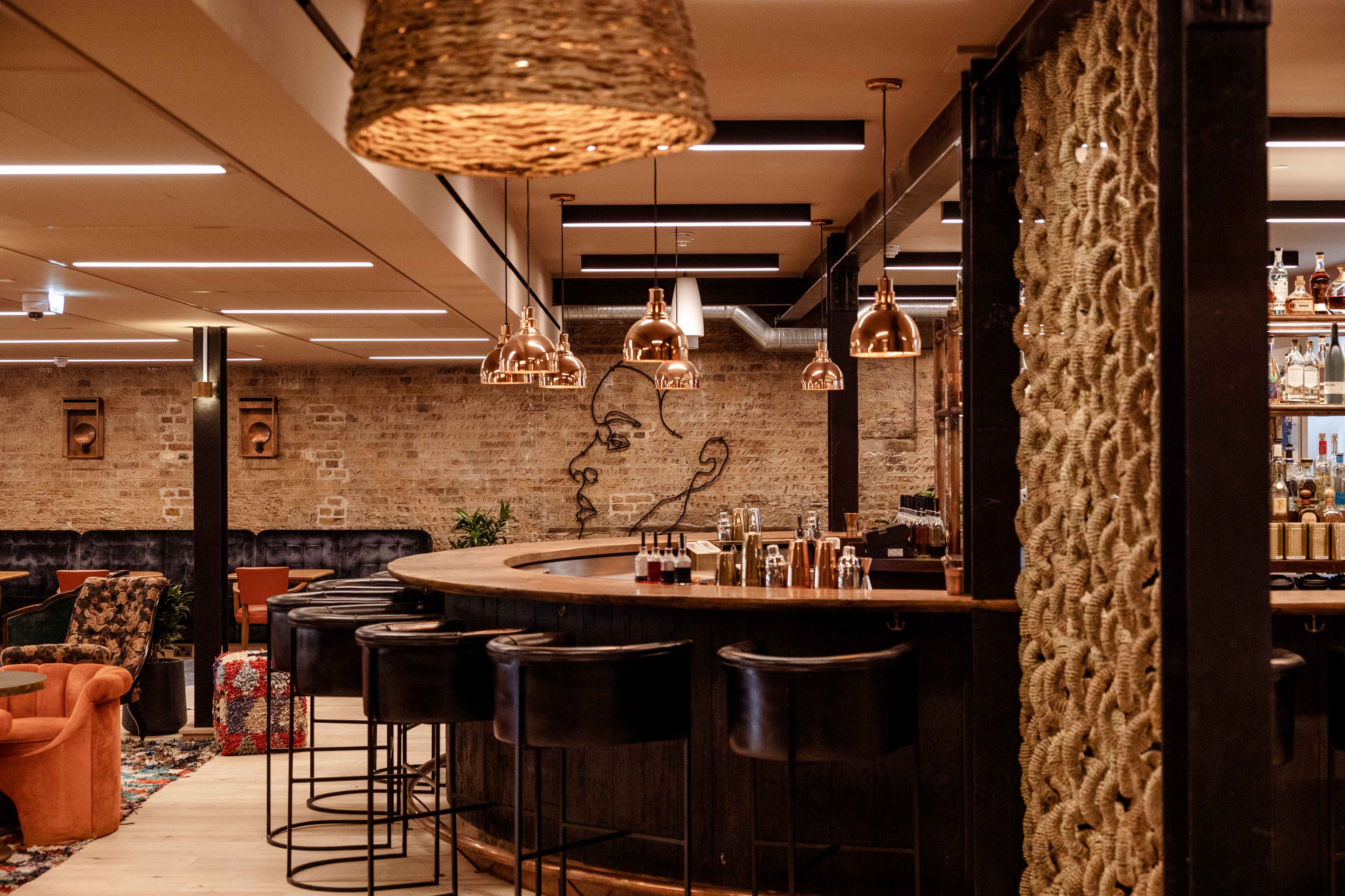 Stylish bar at Ubuntu Lounge, warm lighting for networking events and gatherings.