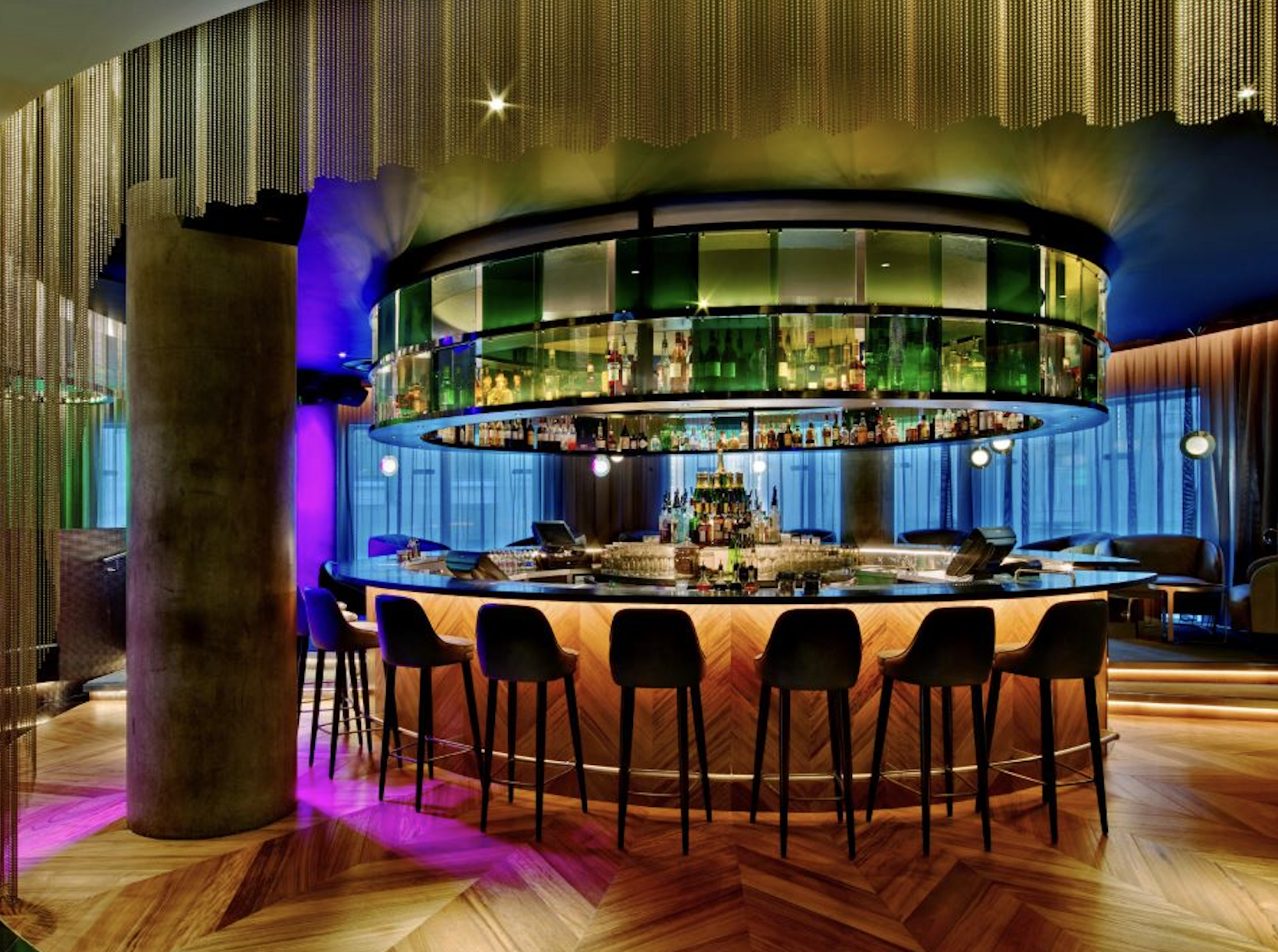 Modern bar at W London with circular design, ideal for networking events and social gatherings.