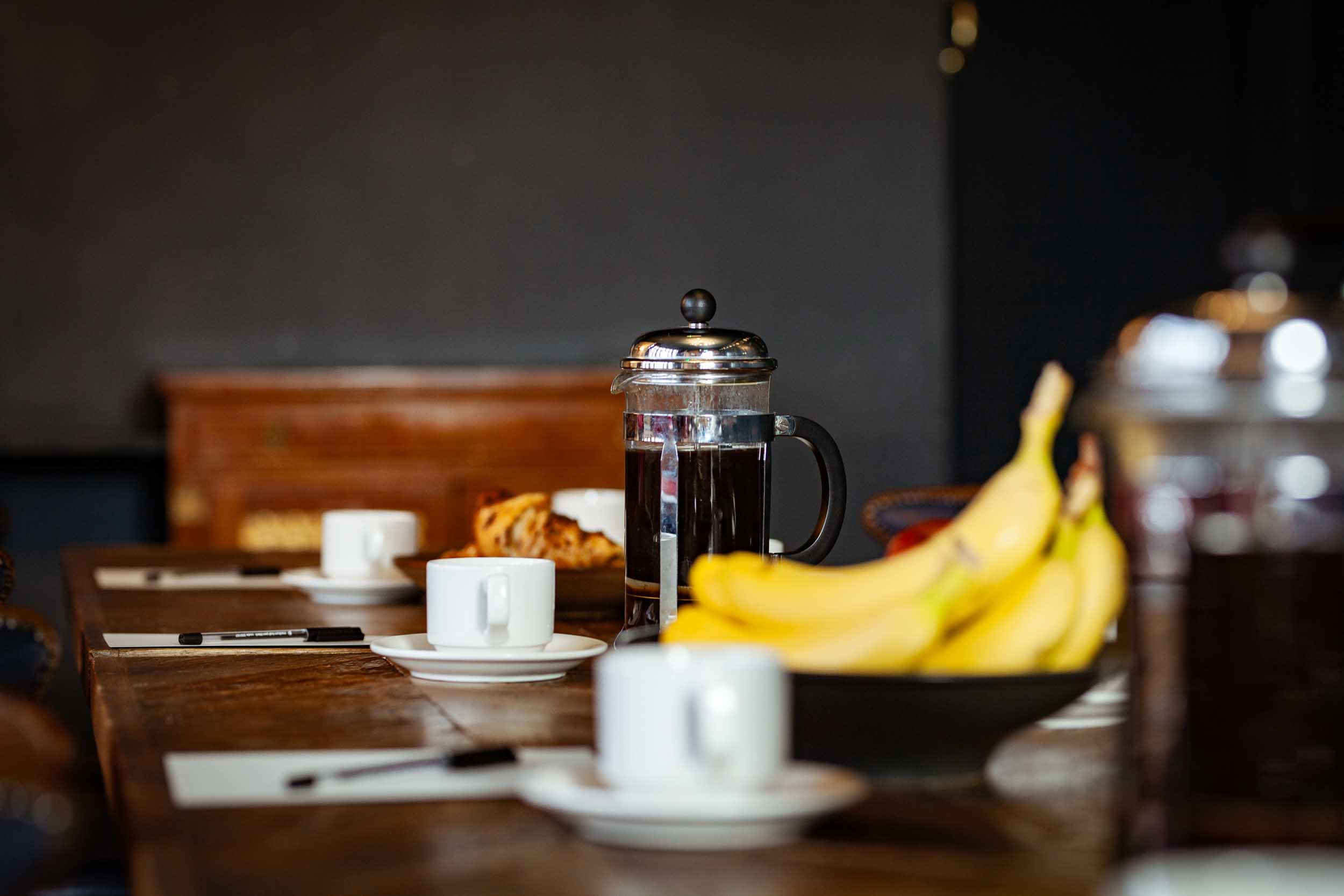Meeting setup with long table, coffee, pastries in The Railway's First Floor Lounge.