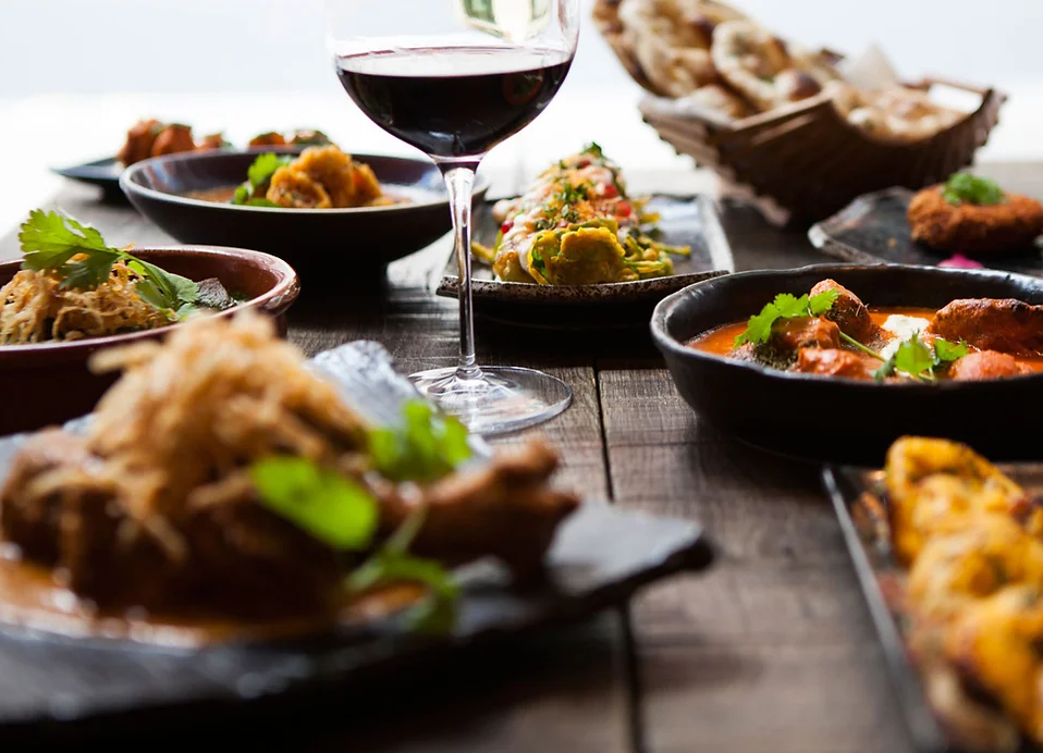 Elegant dining table with vibrant dishes for culinary networking event at Roti Chai.