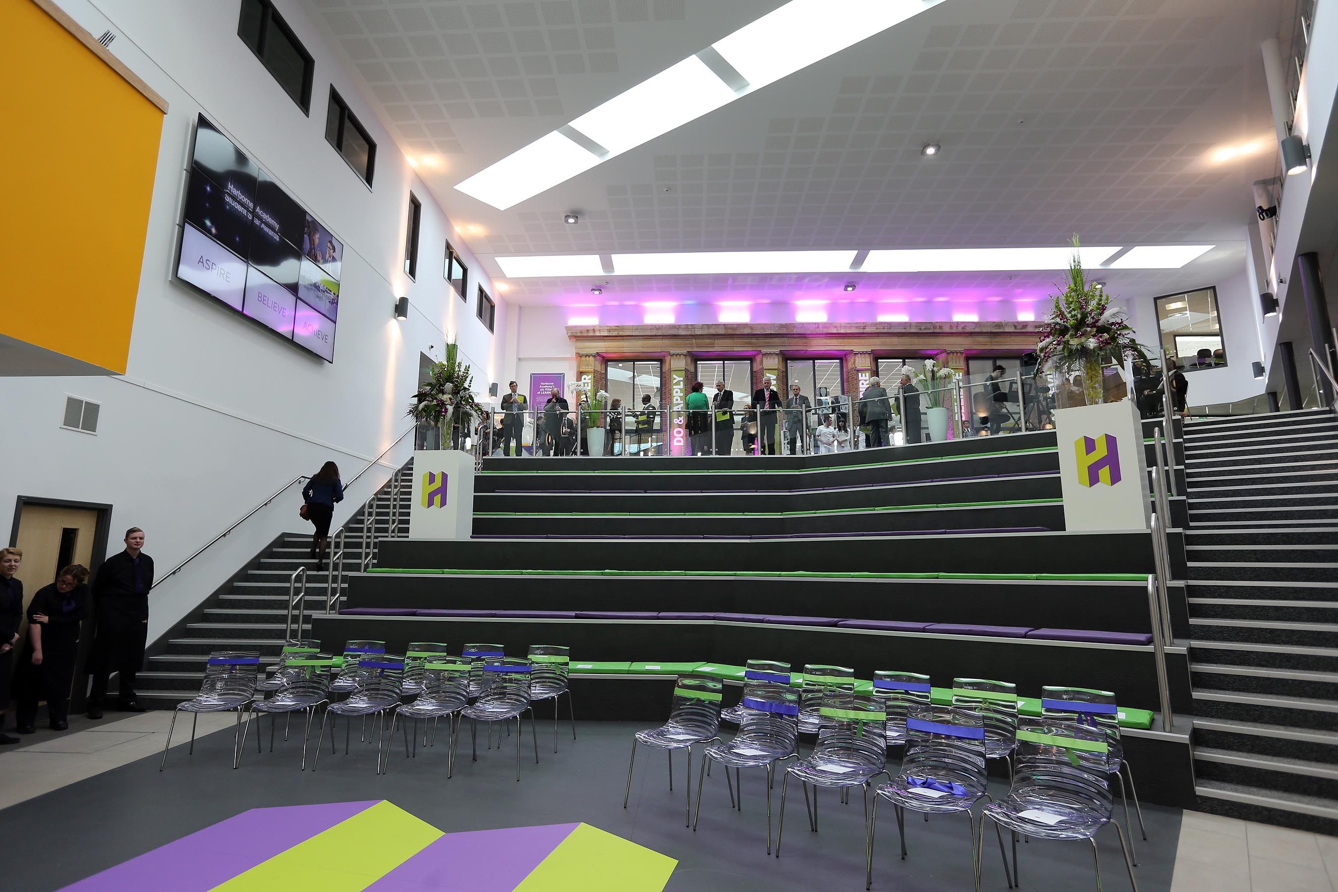 Atrium at Harborne Academy: modern event space with tiered seating for presentations and networking.