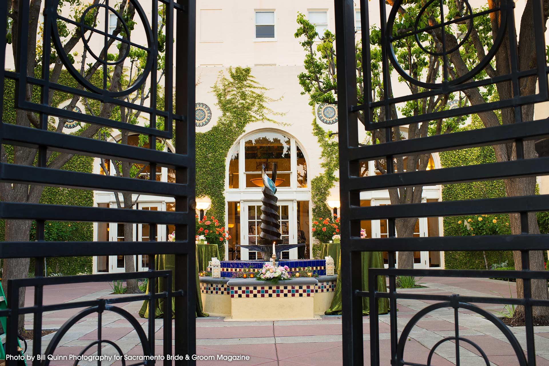 Enclosed patio with elegant gates and fountain, perfect for outdoor events at Historic Hotel Woodland.