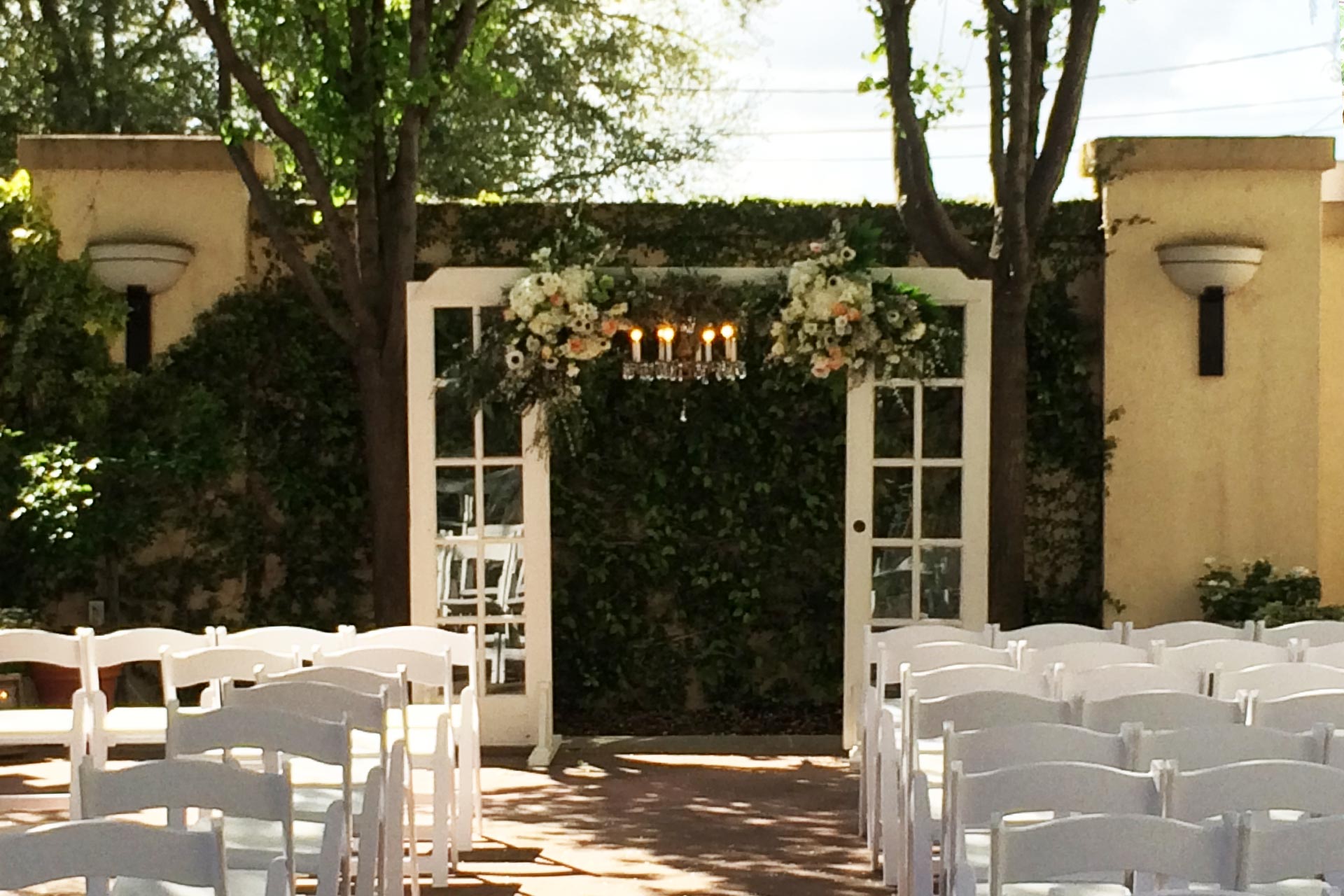 Enclosed patio with floral arch, ideal for romantic weddings and special events.