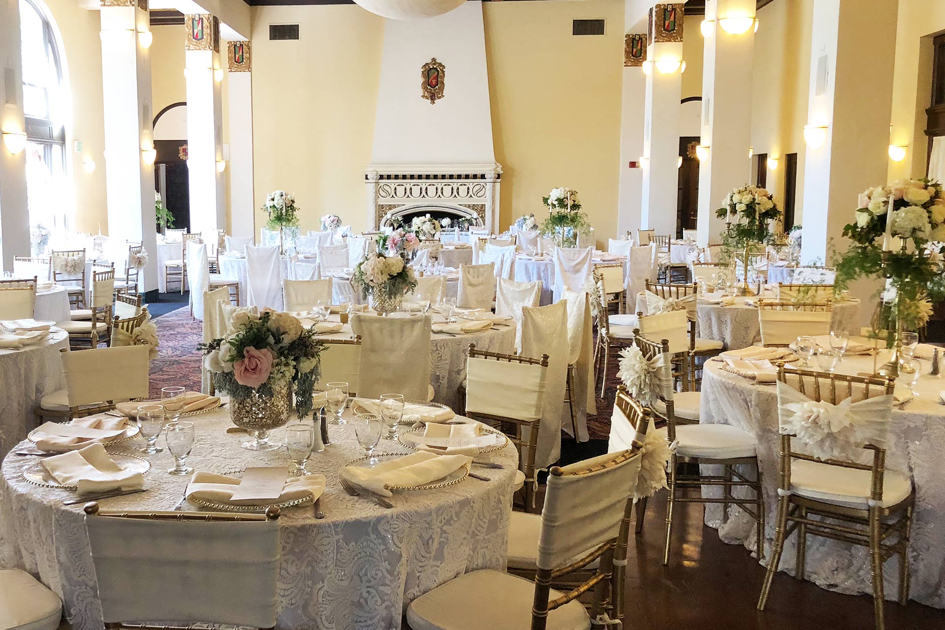 Elegant ballroom with lace tablecloths, perfect for weddings and corporate events.