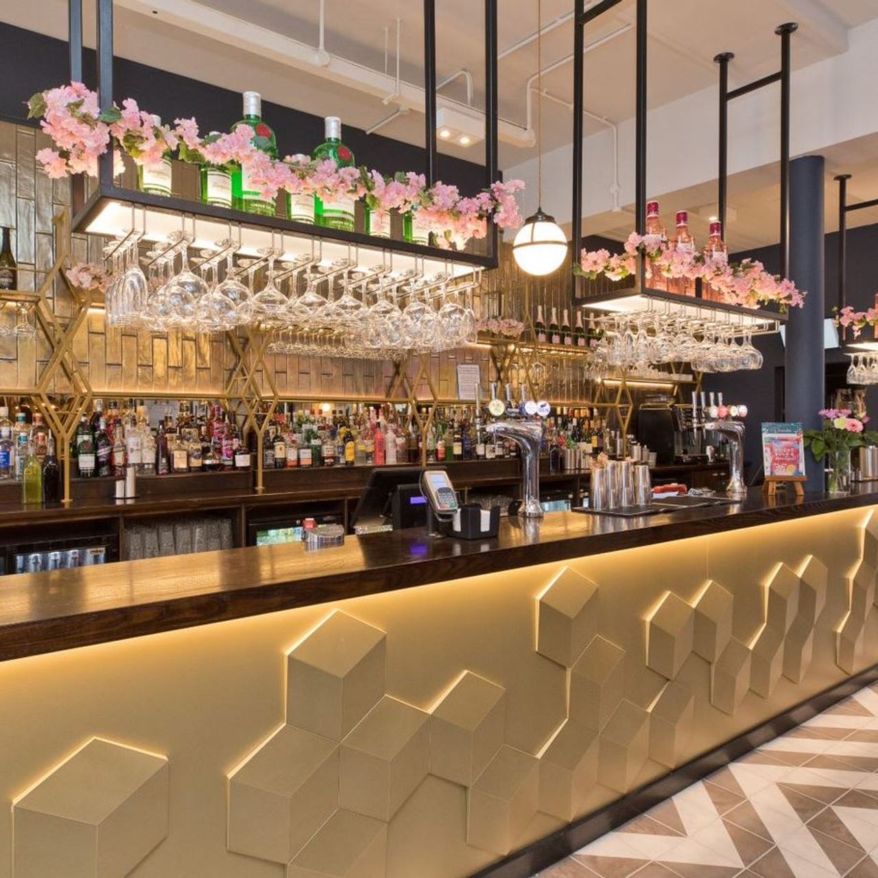 Stylish bar with floral accents at Slug And Lettuce Harborne for networking events.