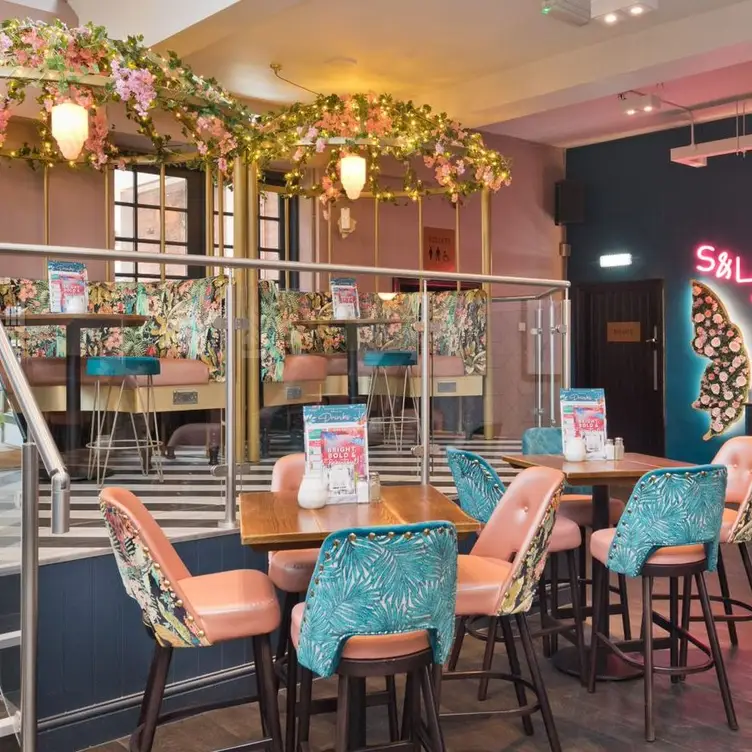 Vibrant bar with colorful seating in Slug And Lettuce Harborne, ideal for events.