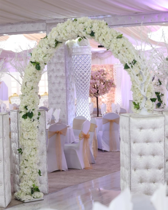 Elegant conference hall with floral archways, perfect for weddings and galas.