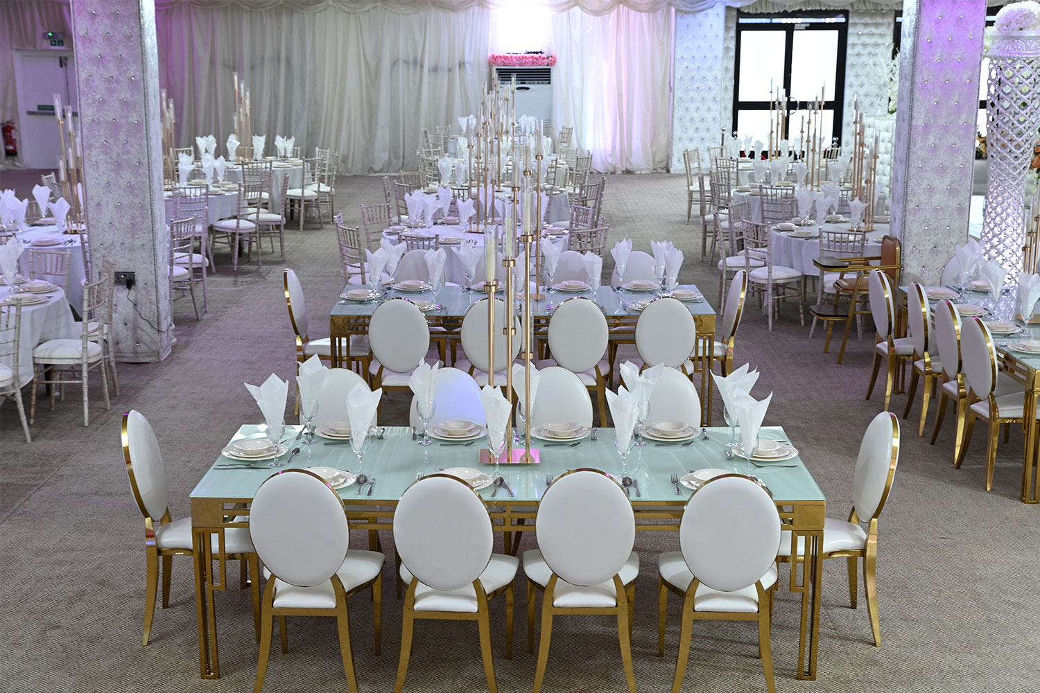 Elegant conference hall with round tables, ideal for weddings and corporate events.