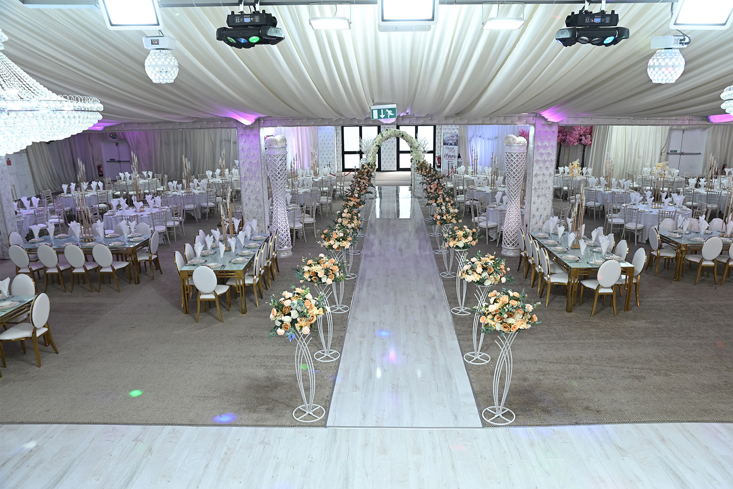 Elegant conference hall with round tables, perfect for weddings and formal events.
