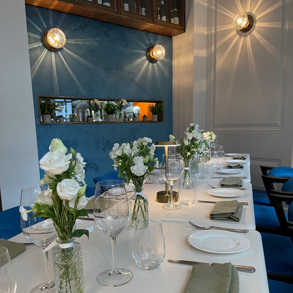 Elegant dining table with white flowers in 104 Restaurant for corporate events or celebrations.