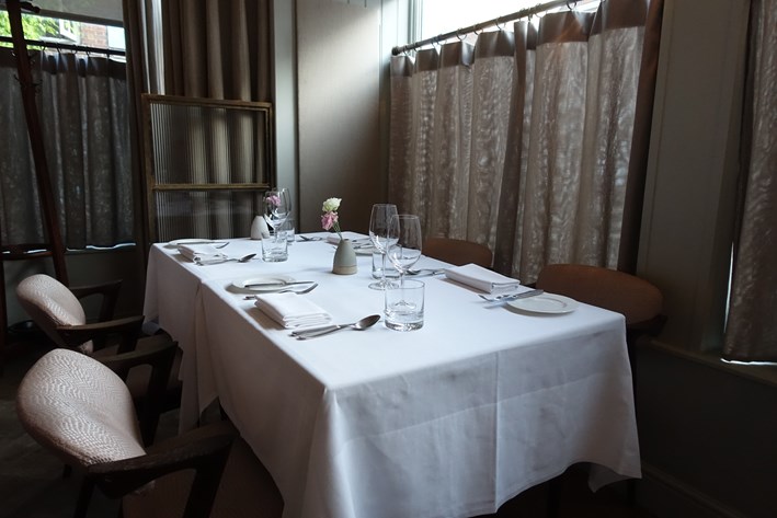 Elegant dining table in private room, perfect for intimate meetings and events.