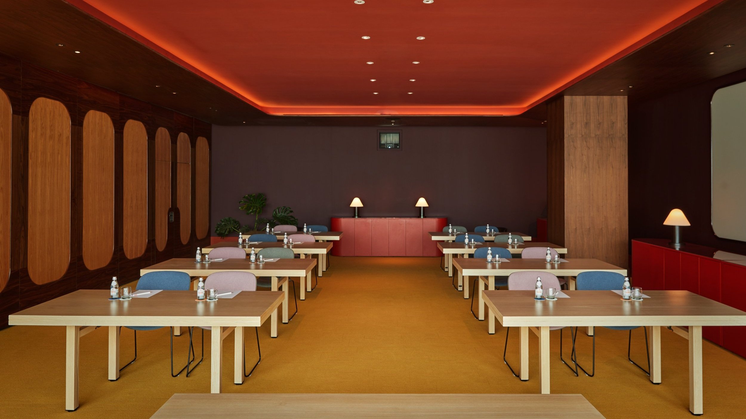 Boom meeting space with tables, warm lighting for productive workshops and events.