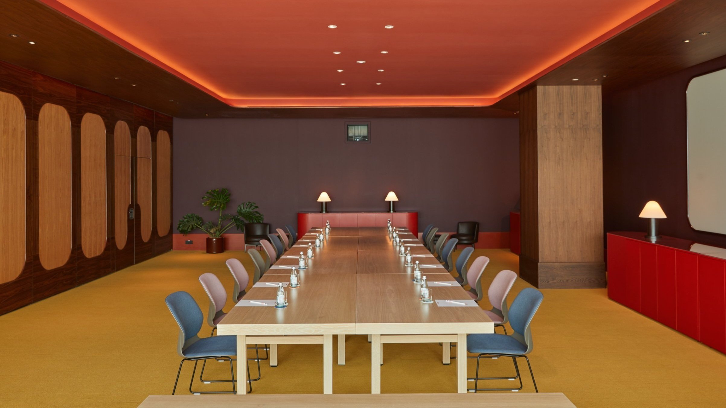 Modern conference room with long table, ideal for private events and meetings.