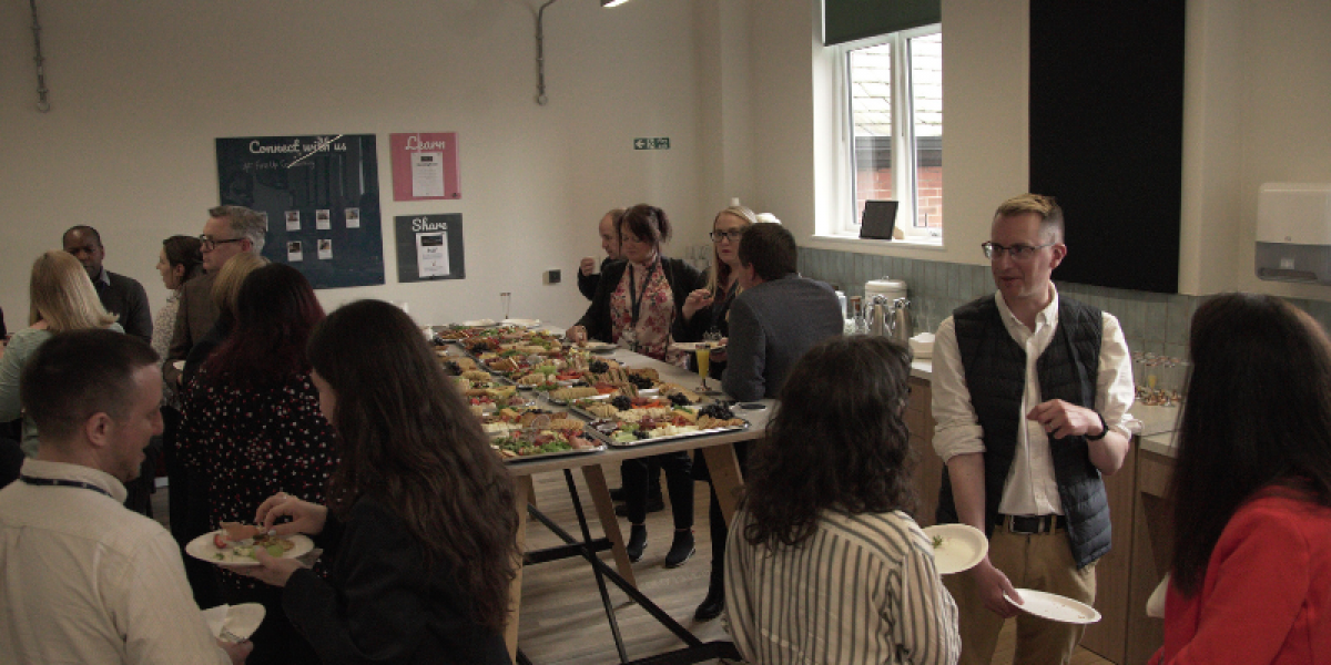Vibrant networking event at Fire Up Rochdale with buffet spread and engaging attendees.