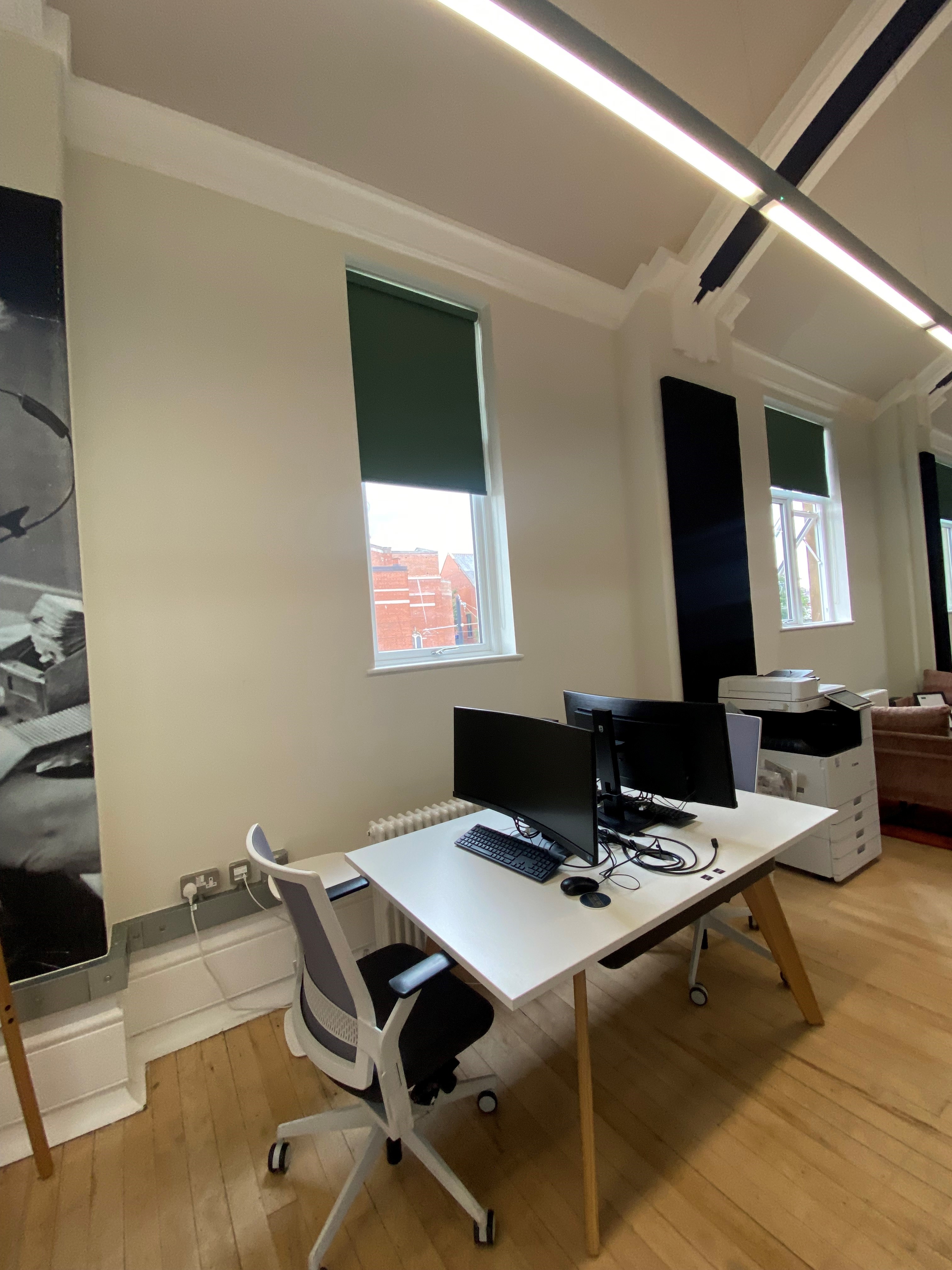 Modern office workspace in Fire Up Rochdale with dual monitors for meetings and events.
