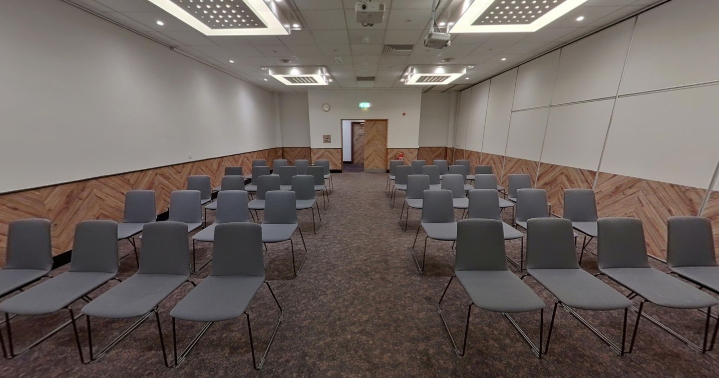 Meeting room at Novotel Birmingham Centre with gray chairs for presentations and workshops.