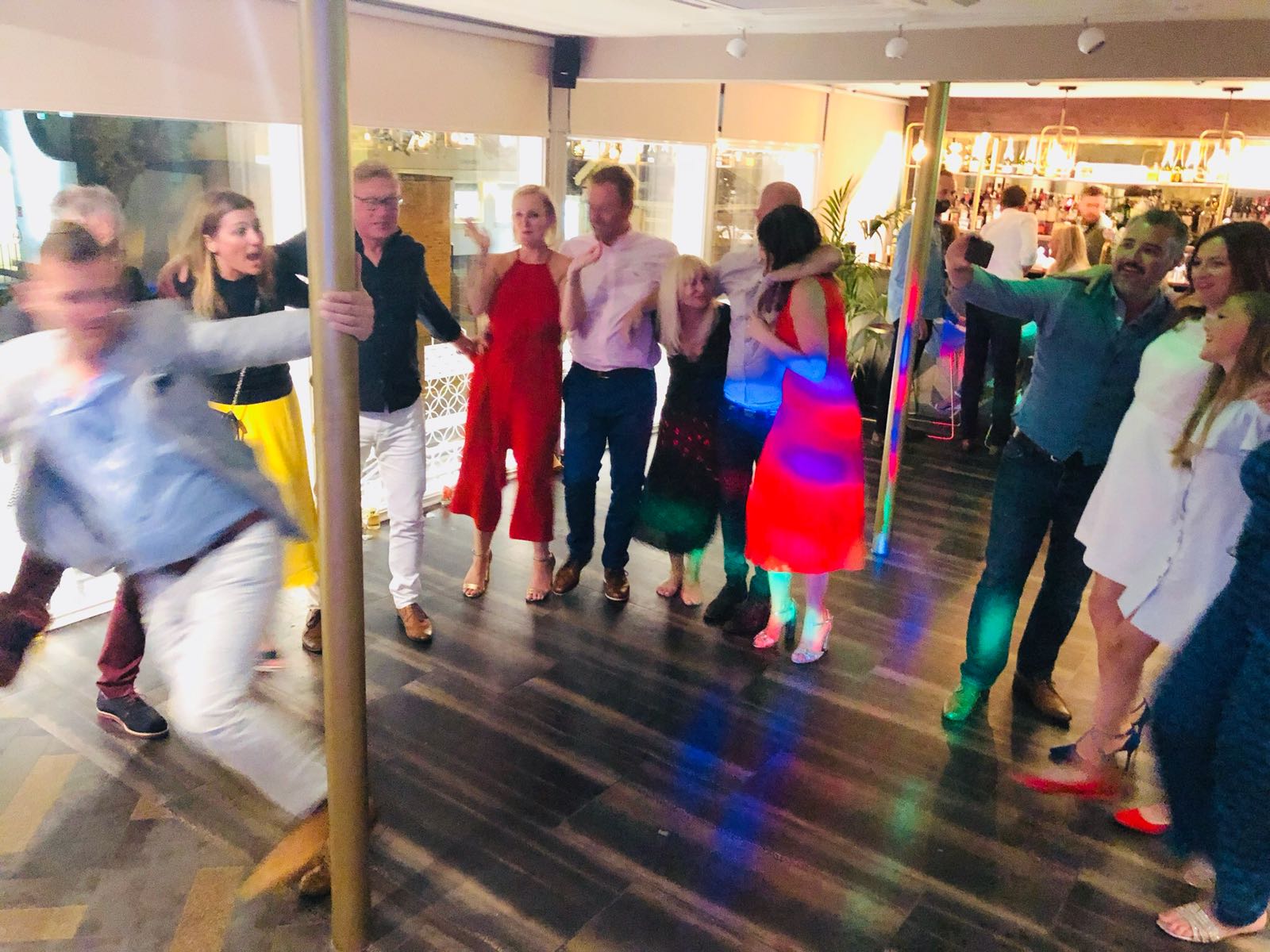 Private dining room at The High Field, vibrant event atmosphere with dancing guests.