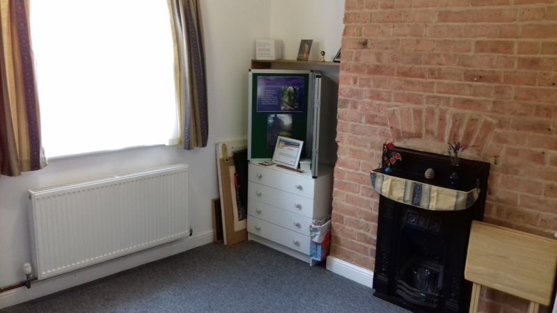 Cozy meeting space at Vesta Living with natural light and brick wall for brainstorming sessions.