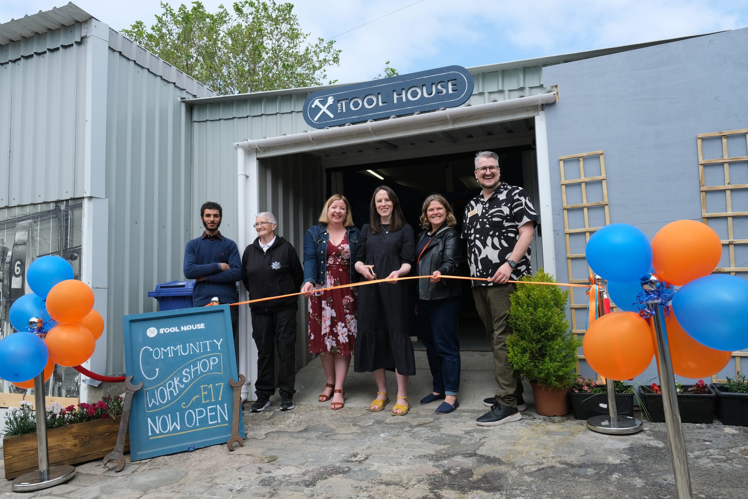 Ribbon-cutting ceremony at The Twelfth House community workshop, showcasing local engagement.