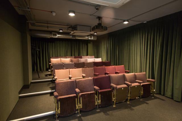 Private cinema in Karma Sanctum Soho, London, with tiered seating for corporate events.