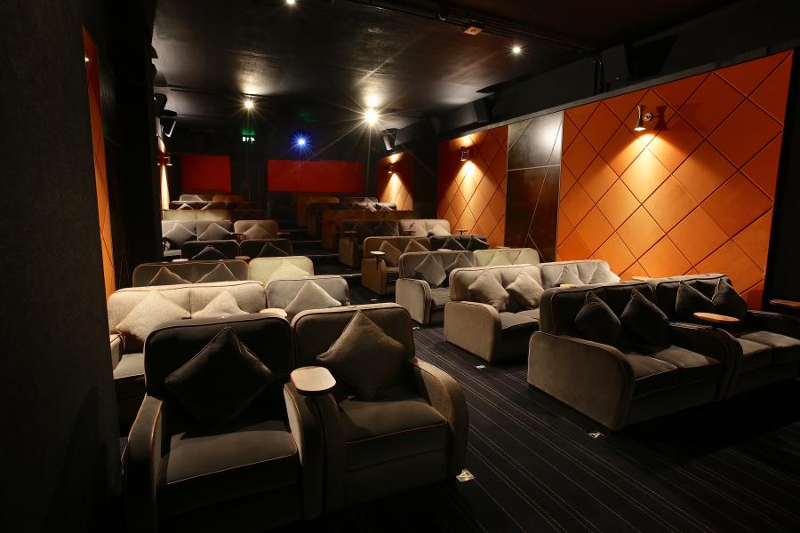 Private cinema in Karma Sanctum Soho, London with plush seating for exclusive screenings.