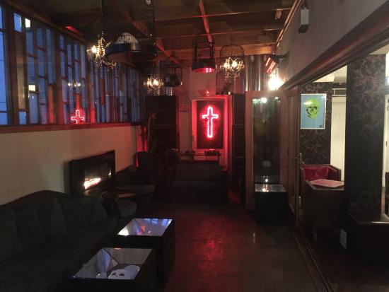 Rooftop bar in Karma Sanctum Soho, London, with neon accents for events and gatherings.